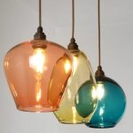 a set of three semi-transparent large colored glass pendant lights